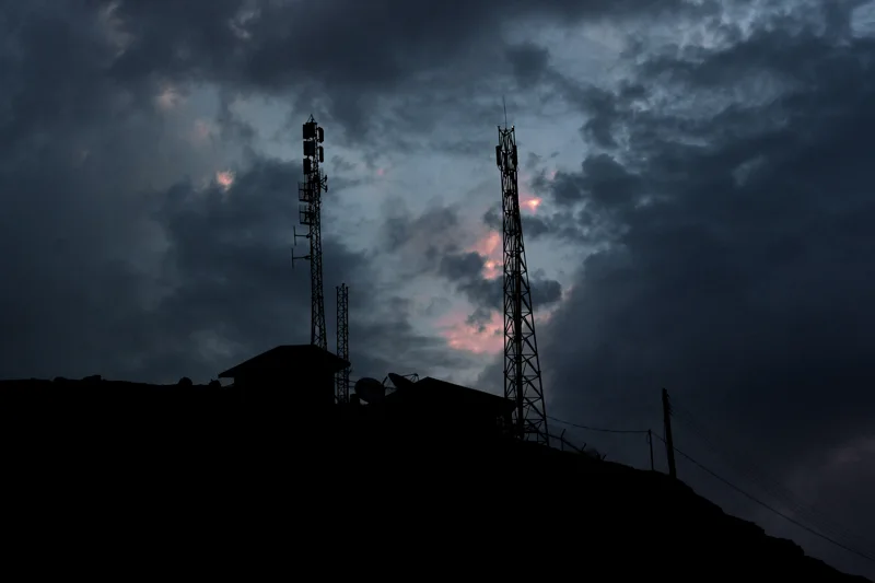 Two towers beneath dramatic dark storm clouds